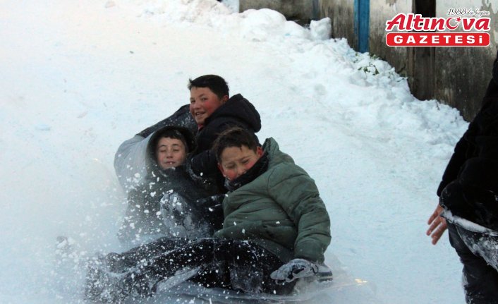 Mahalle yolunu kızak pistine çeviren çocuklar karın tadını çıkardı