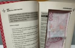 Samsun'da sahte parayı saklamak amacıyla kitabın içini para ölçüsünde kesen 2 zanlı yakalandı